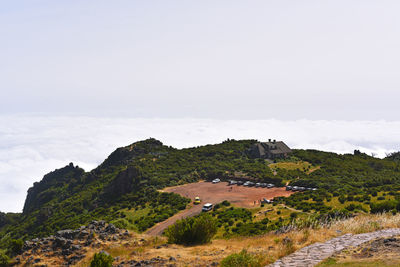 Scenic view of building and mountains against sky