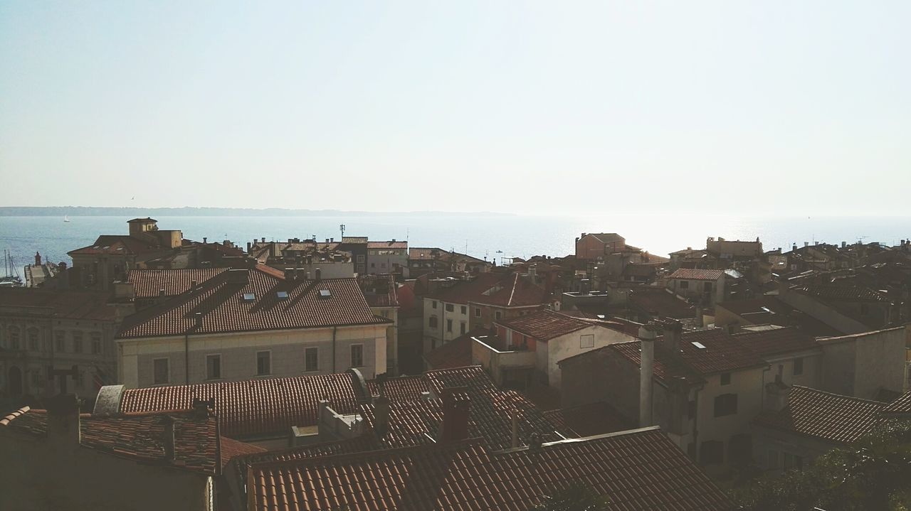 sea, architecture, built structure, building exterior, clear sky, city, day, horizon over water, outdoors, no people, nature, beach, sky, water