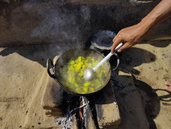 Person hand holding ice cream cone outdoors