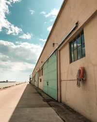 Road amidst buildings against sky