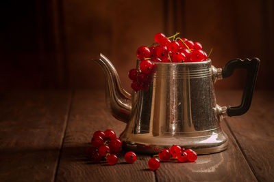 Close-up of cherries in jar on table