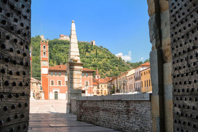 Buildings in town against clear blue sky