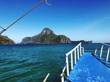 Scenic view of bay against clear blue sky