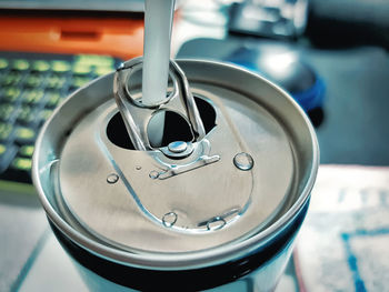 Soft drink can with straw on the desk