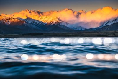 Scenic view of snowcapped mountains against sky during sunset