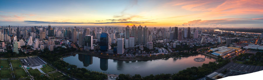 High angle view of modern buildings against sky during sunset