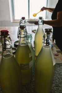 High angle view of water kefir in bottles on counter