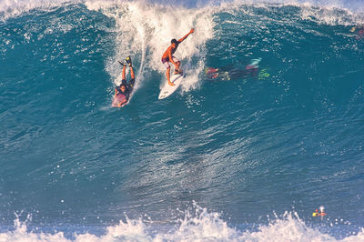 High angle view of people swimming in sea