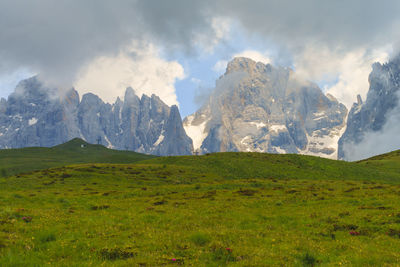 Scenic view of mountains against cloudy sky