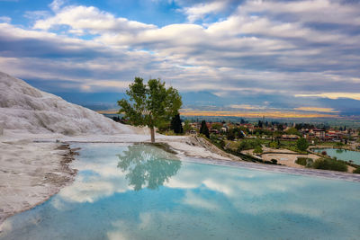 Scenic view of swimming pool by lake against sky