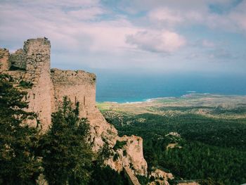 Scenic view of rock formations against cloudy sky