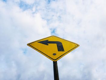 Low angle view of road sign against sky