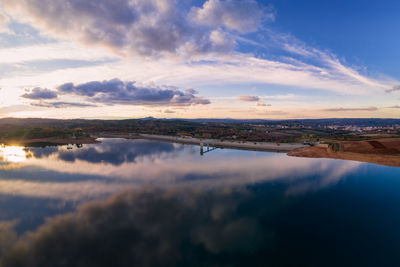 Drone aerial panoramic view of sabugal dam lake reservoir with perfect reflection, in portugal