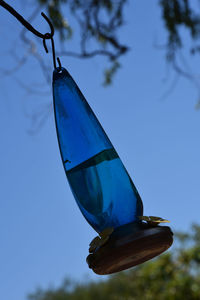 Low angle view of bird flying against clear blue sky