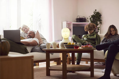 Family with children relaxing in living room