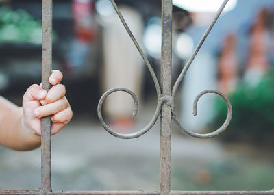 Close-up of hand holding metal