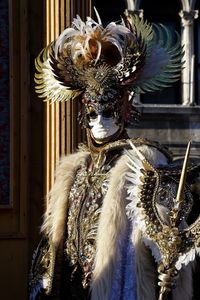 Person in carnival costume holding cane