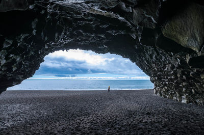 Scenic view of sea seen through cave