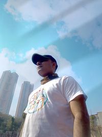 Low angle view of man standing against sky