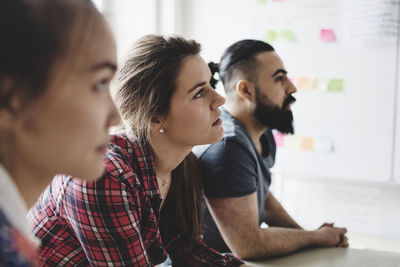 Close-up of business people during meeting in creative office