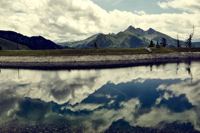 Scenic view of lake and mountains against sky