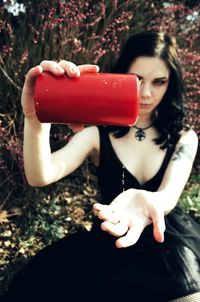 Portrait of young woman holding red rose