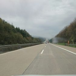 Empty road passing through landscape