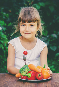 Portrait of cute girl eating fruit