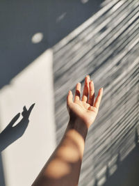 High angle view of woman shadow on hand