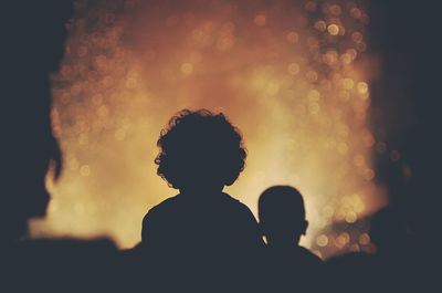 Close-up of silhouette people against sky at night