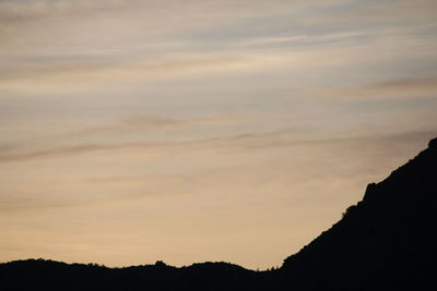 Scenic view of silhouette mountains against sky during sunset