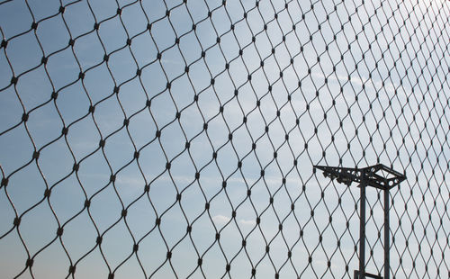 Low angle view of chainlink fence against clear sky