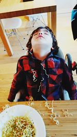 Cute girl sitting on table at restaurant