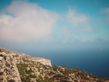 Scenic view of sea and mountains against sky