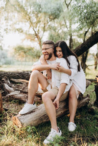 Young couple sitting outdoors