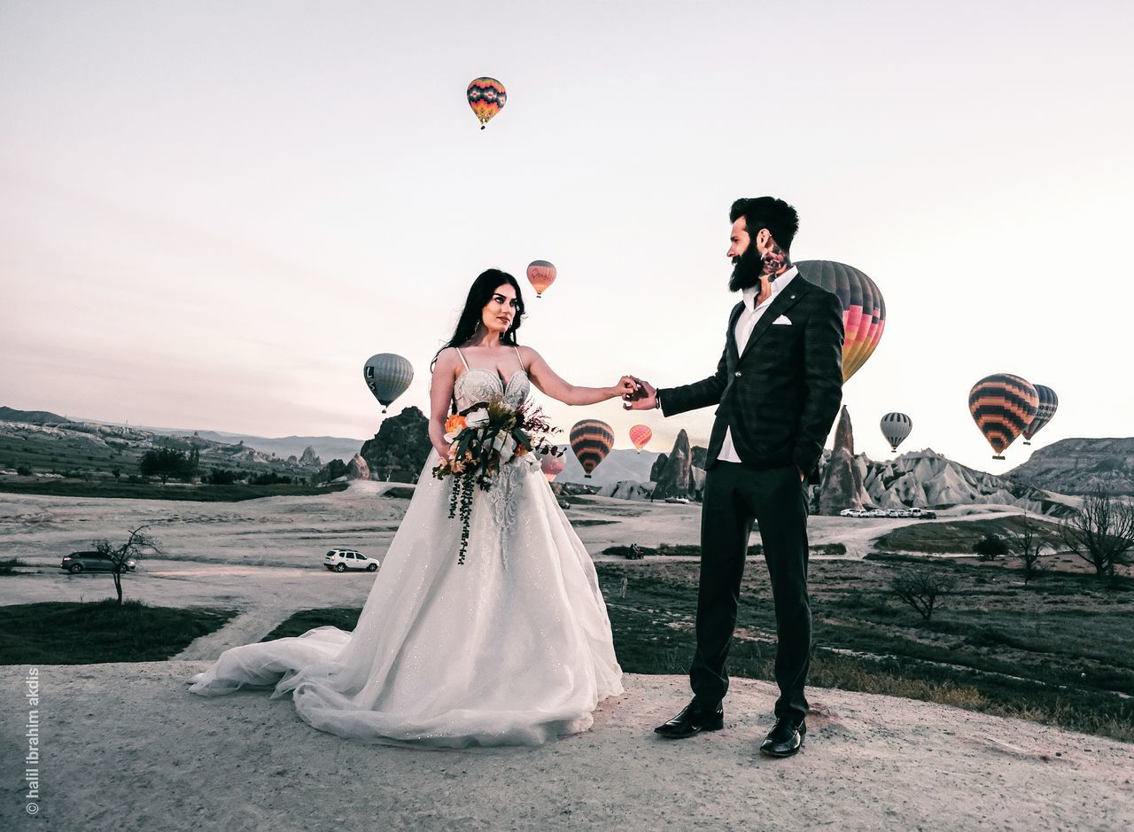 COUPLE KISSING AGAINST CLEAR SKY