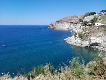 Scenic view of sea against clear blue sky