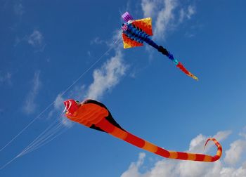 Low angle view of kite flying against blue sky