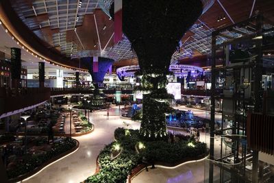 High angle view of road amidst buildings in city at night