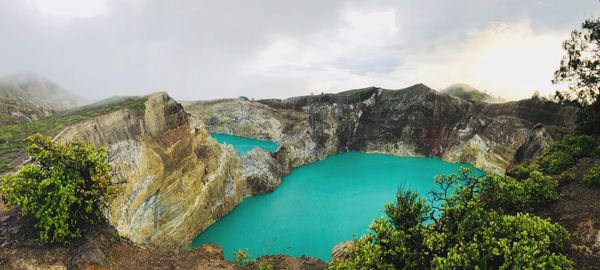 Panoramic view of sea and mountains against sky