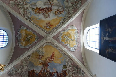 Low angle view of stained glass window in building