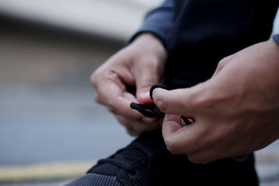 Midsection of man using mobile phone