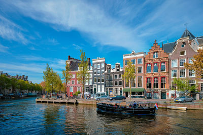 Amsterdam view - canal with boat, bridge and old houses