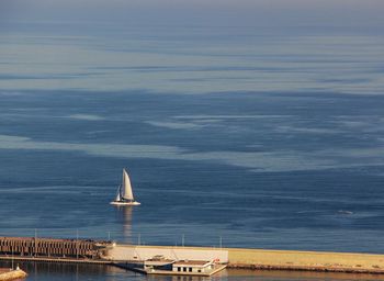 Sailboat on sea against sky