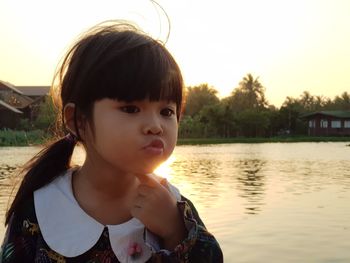 Portrait of girl standing against sky