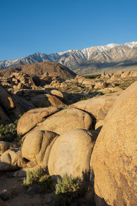 Scenic view of landscape and mountains against clear blue sky