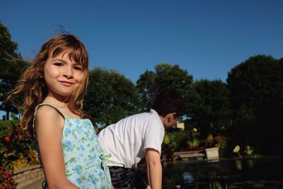 Portrait of girl standing by brother