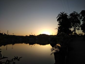 Scenic view of lake against sky at sunset