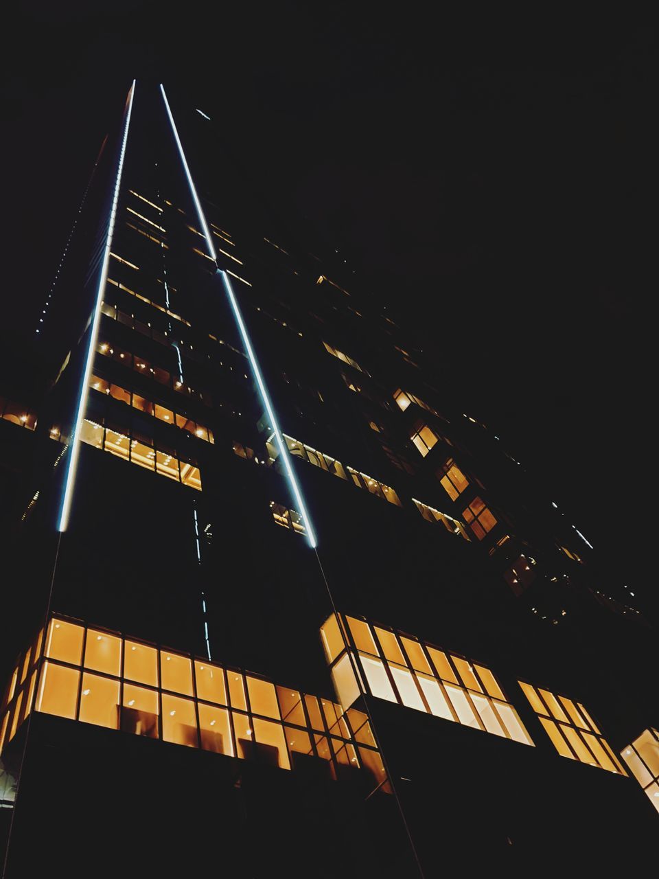 LOW ANGLE VIEW OF ILLUMINATED BUILDINGS AGAINST CLEAR SKY