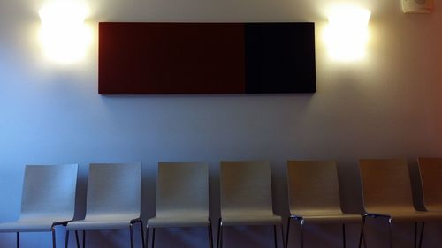 Empty chairs against wall at home